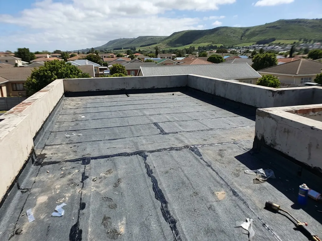 Flat-roof waterproofing system installed for a Cape Town home — engineered for wind-driven winter rain